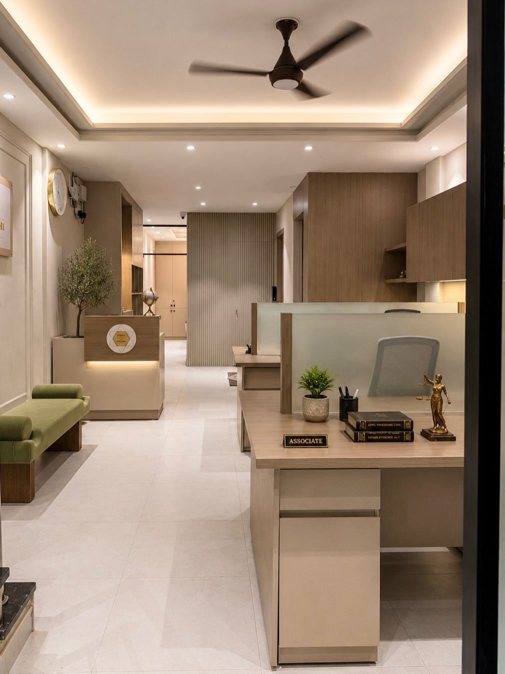 Modern office interior with a reception area and a workstation with wooden furniture.
