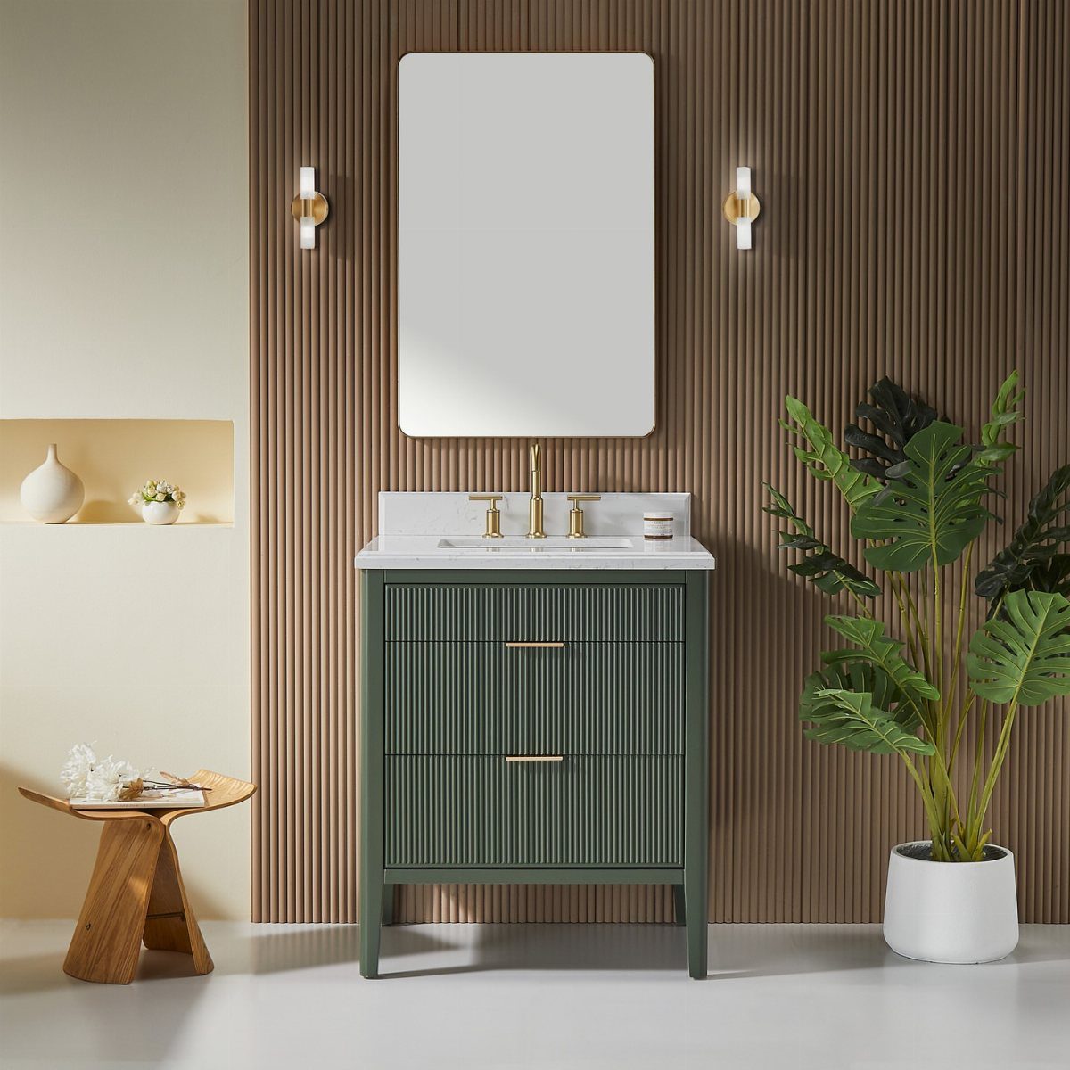 Green fluted bathroom vanity with white marble top and gold fixtures against slatted wall