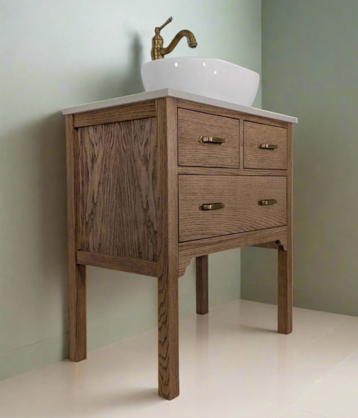 Wooden bathroom vanity with white vessel sink and gold faucet against green wall