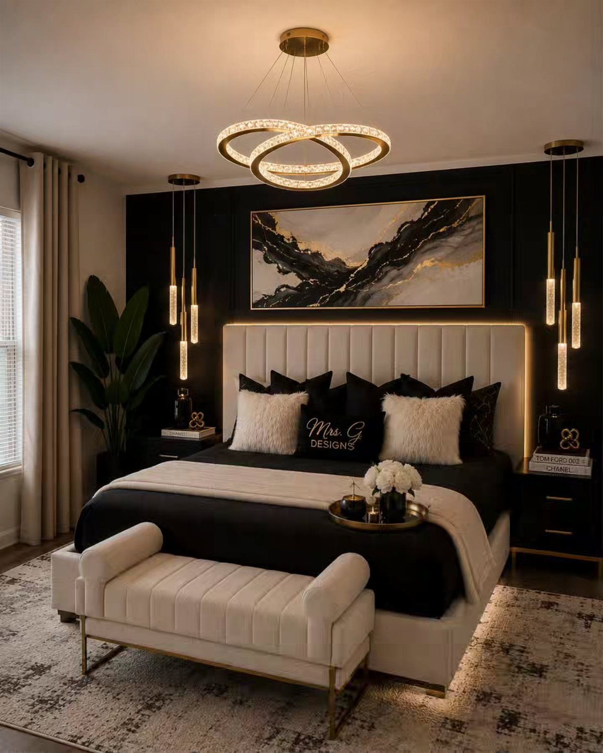 Luxurious bedroom with black accent wall, gold lighting, and white tufted furniture.
