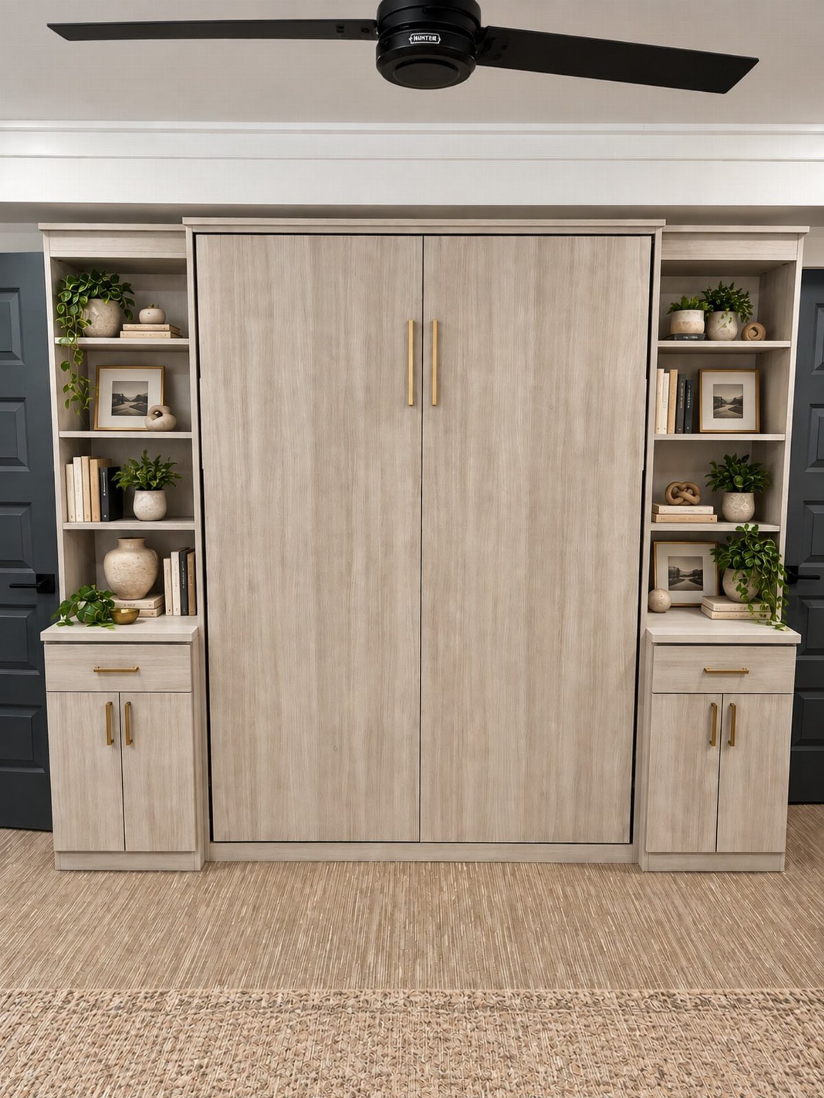 Light wood built-in wall unit with central cabinets and side shelving for decor.