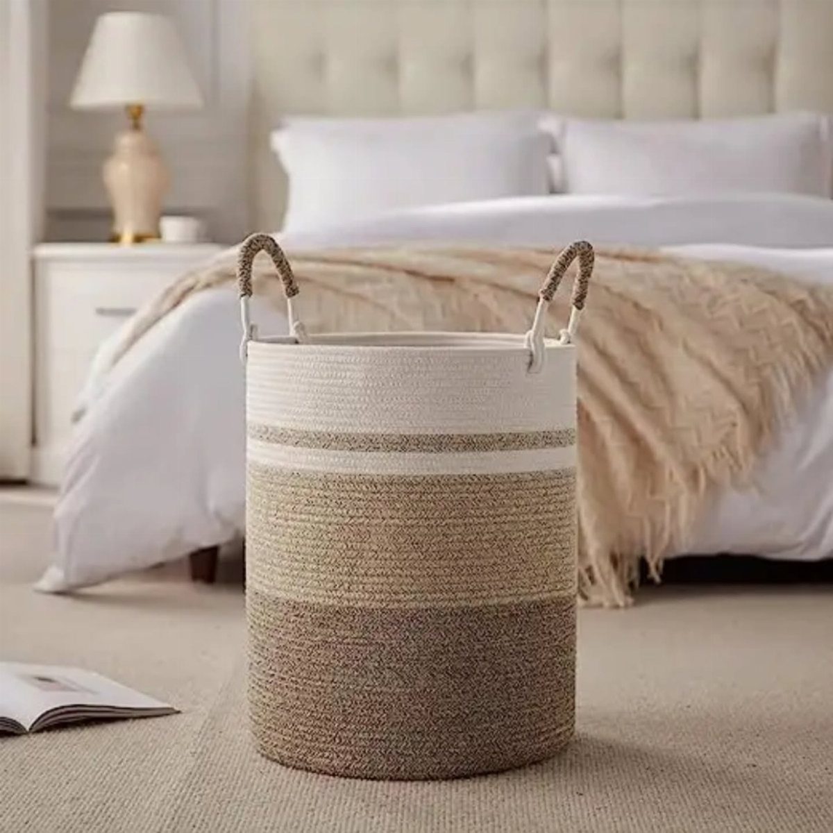 Woven striped storage basket on a beige carpet in a bright bedroom