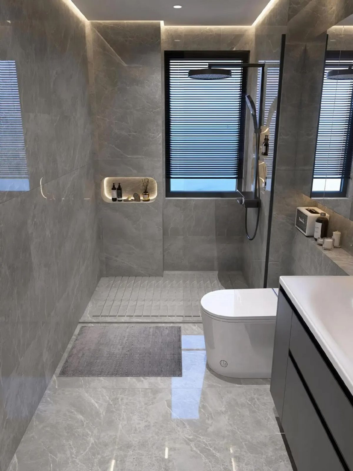 Modern bathroom with gray marble walls, white toilet, and dark gray vanity cabinetry.