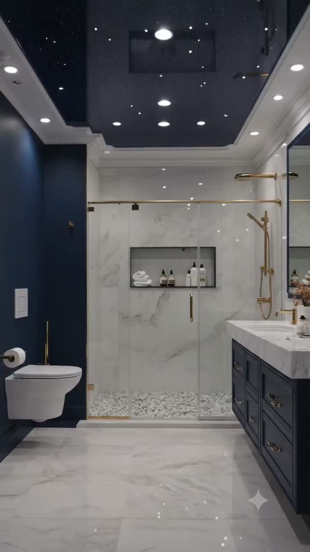 Navy blue bathroom with white marble floors, gold fixtures, and a starry ceiling.