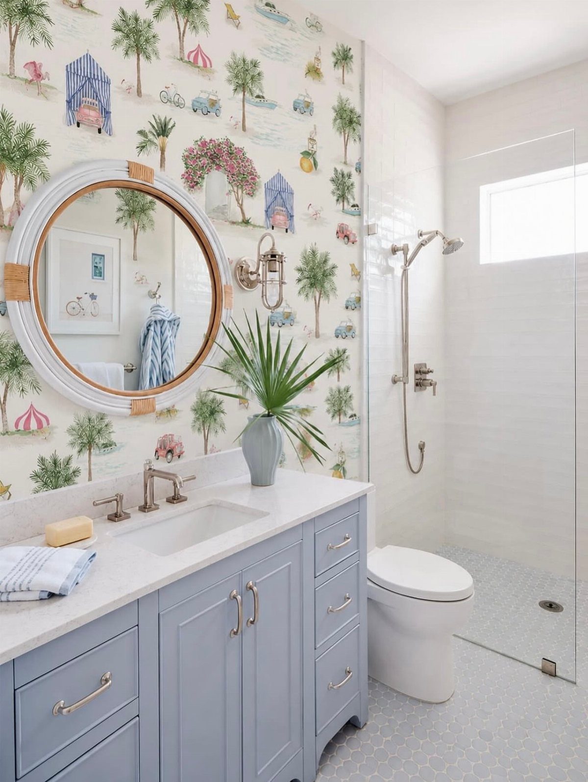 Bathroom with beach-themed wallpaper, light blue vanity, and a white walk-in shower.