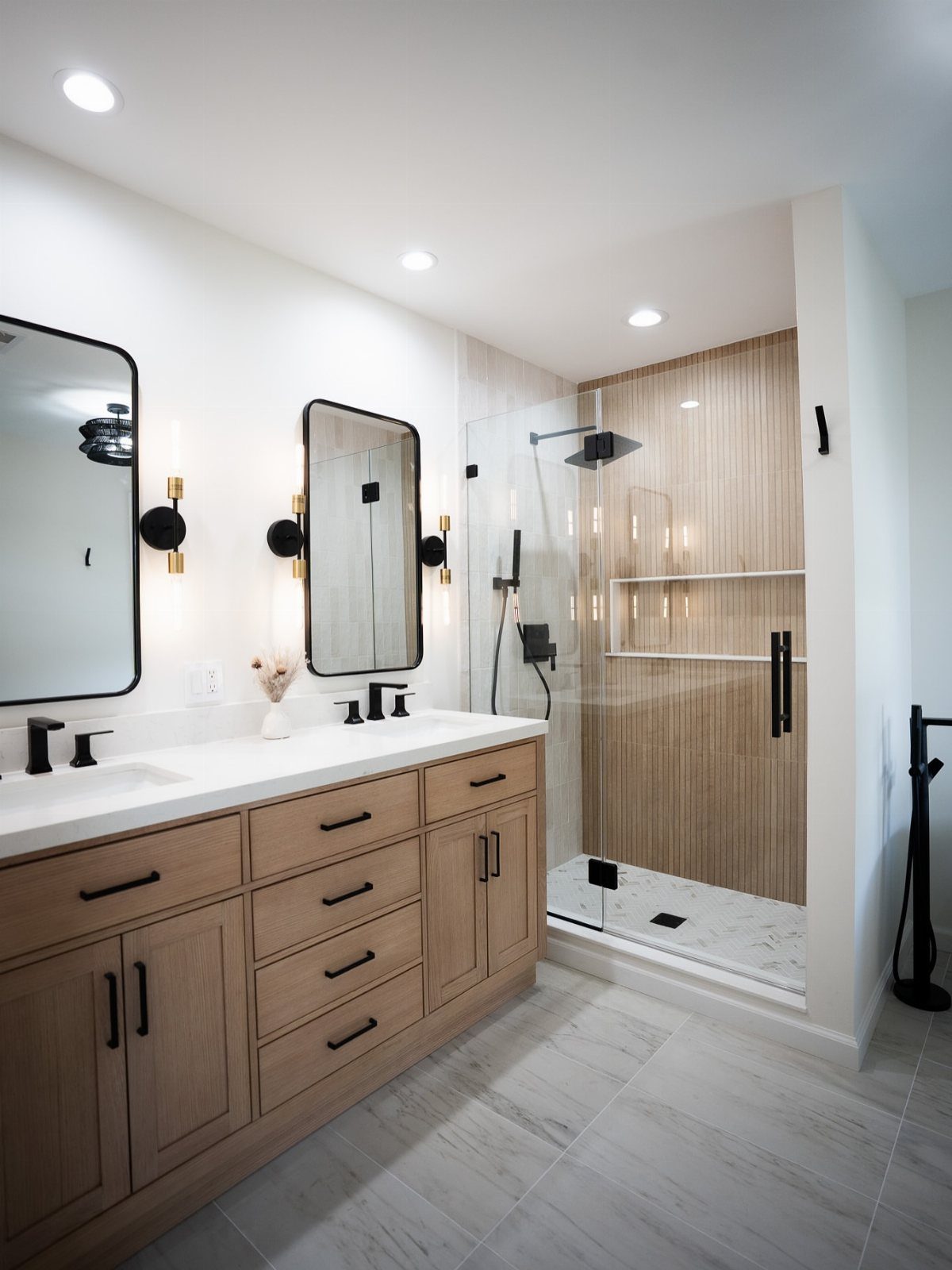 Modern bathroom with a walk-in shower featuring light brown vertical wall tiles.