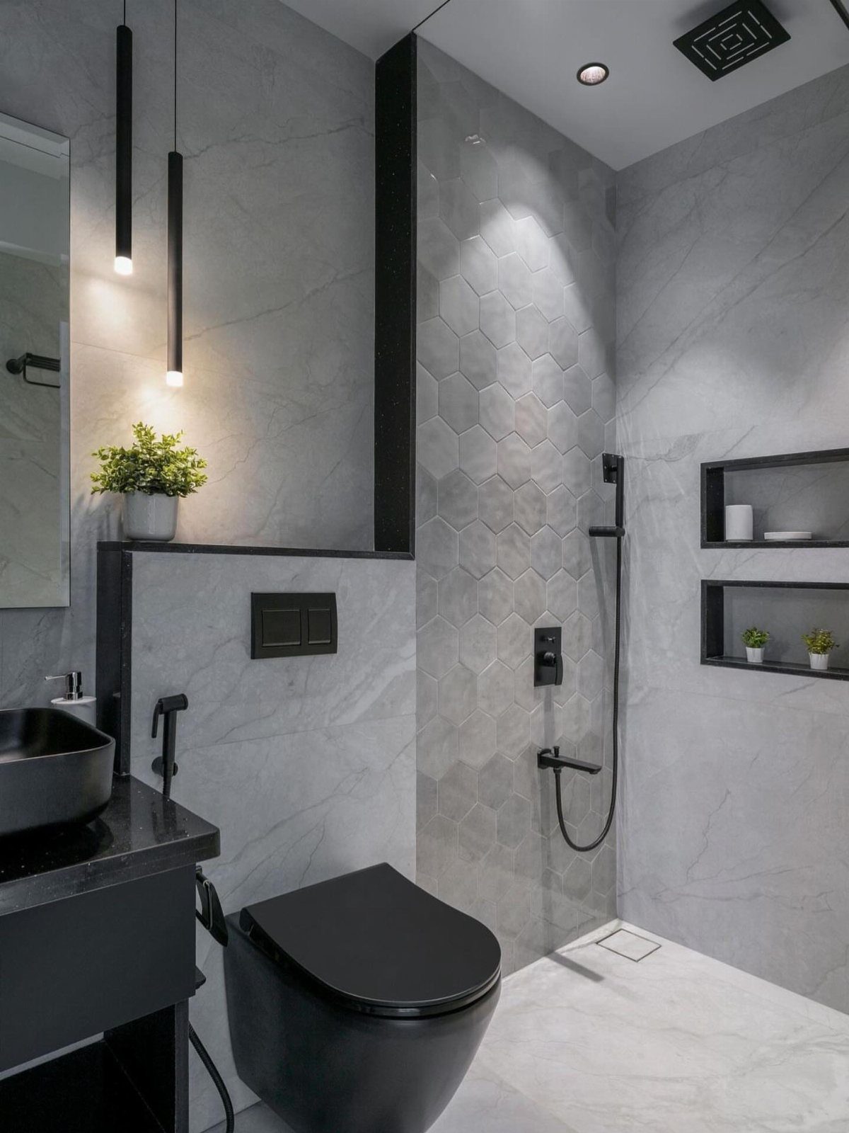 Modern bathroom with white marble walls, black toilet, sink, and black shower fixtures.