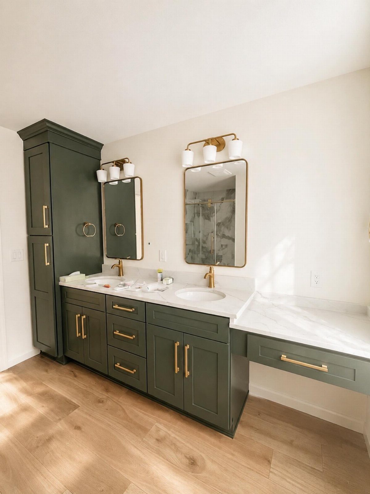 Dark green double sink bathroom vanity with white marble top and gold hardware