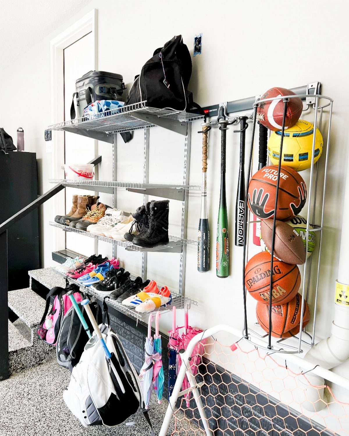 Metal shelving unit and sports equipment rack organizing shoes and bags in a corner