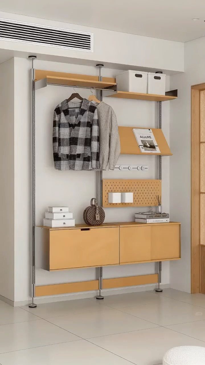 Wall-mounted light wood storage system with cabinets, shelves, and hanging clothes.
