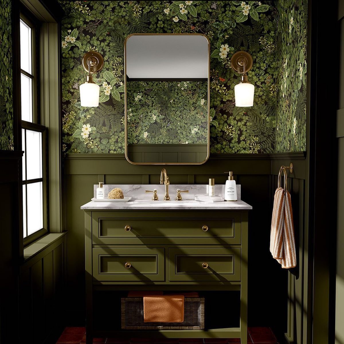 Green bathroom vanity with botanical leaf wallpaper and gold wall sconces
