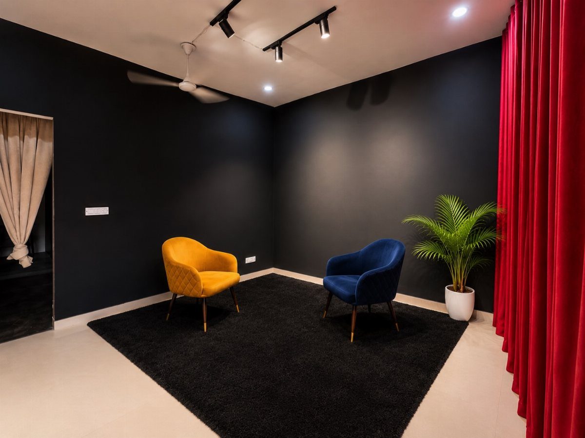 Yellow and blue velvet accent chairs on a black rug against dark walls.