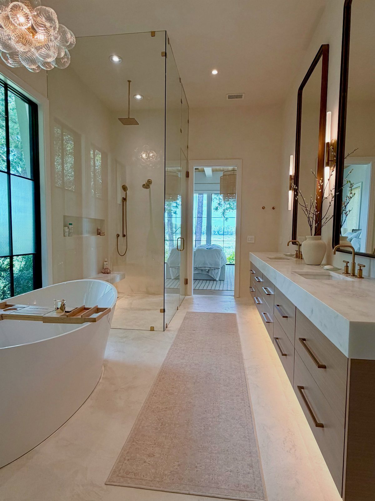 Double vanity with two sinks and gold faucets in a modern white bathroom