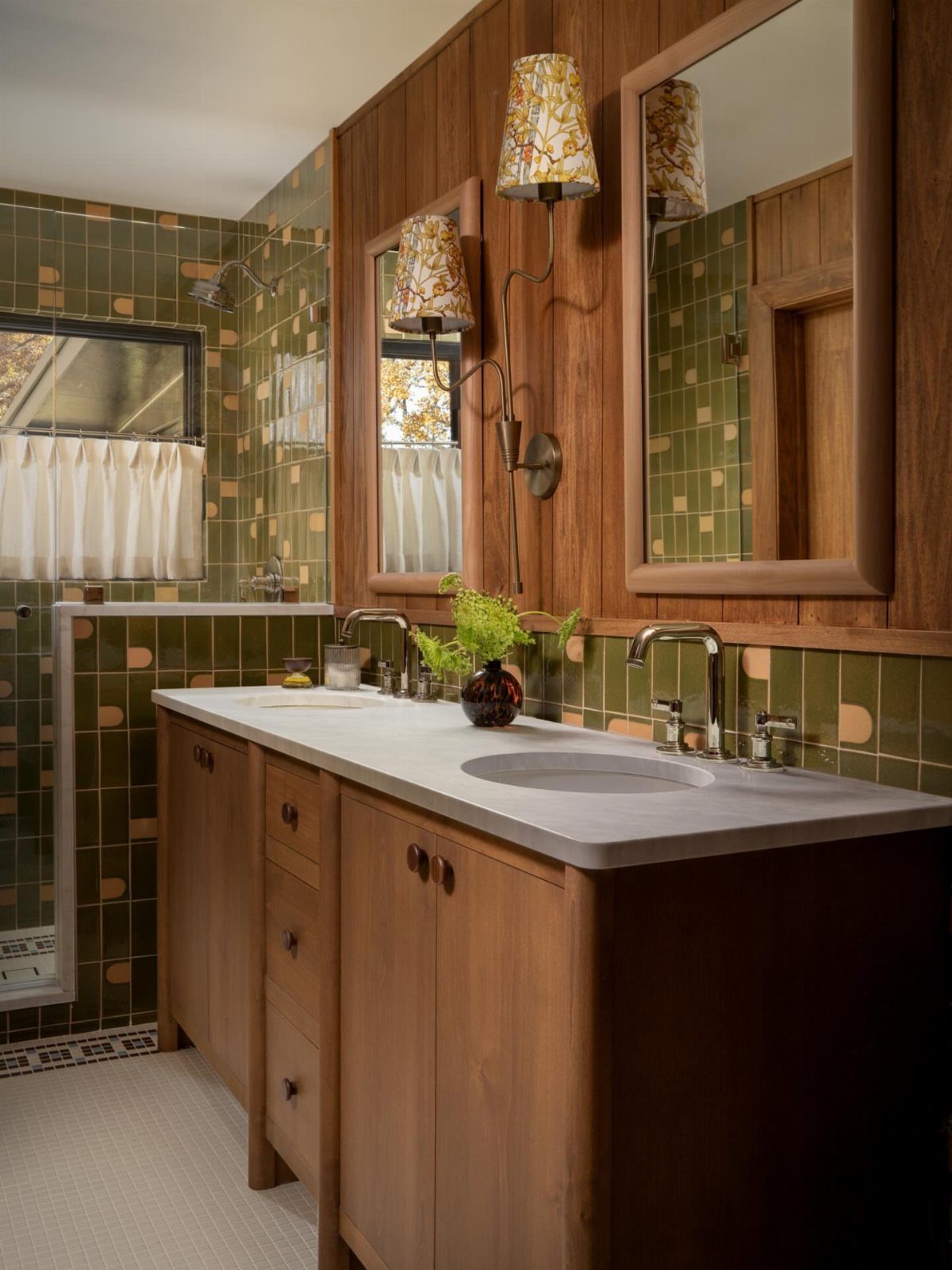 Mid century modern bathroom with wood paneling, green tiles, and a wooden vanity.
