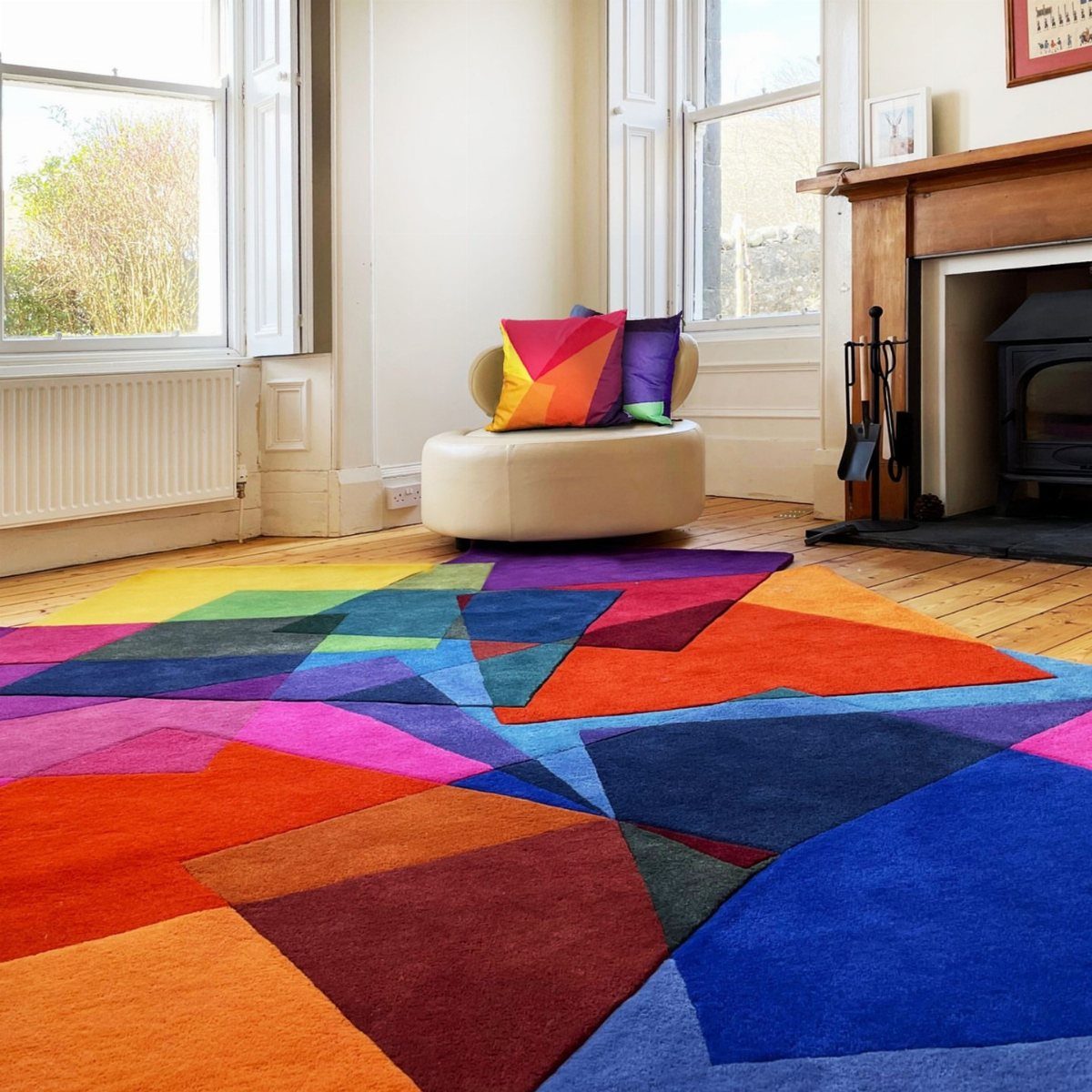 Colorful geometric rug on a wooden floor in a bright living room