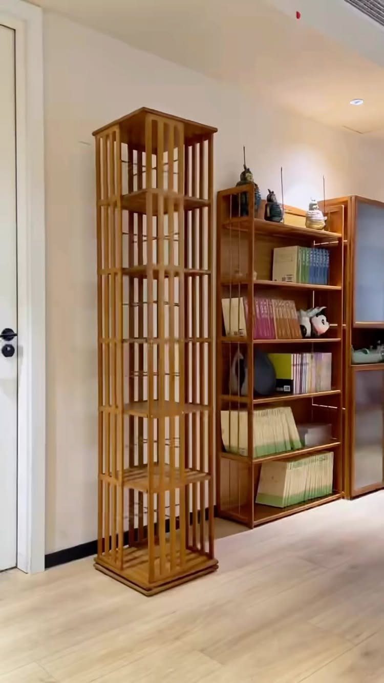 Wooden shelving units with books and decor against a light wall and floor.