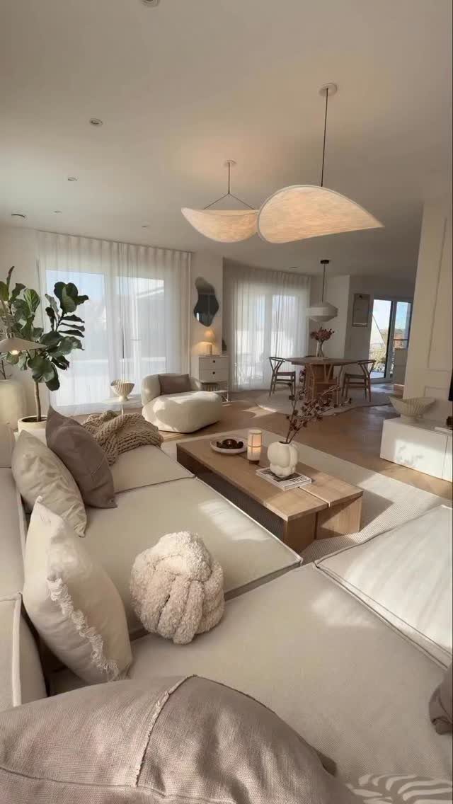 Cream sectional sofa and wooden coffee table in a neutral toned open living space