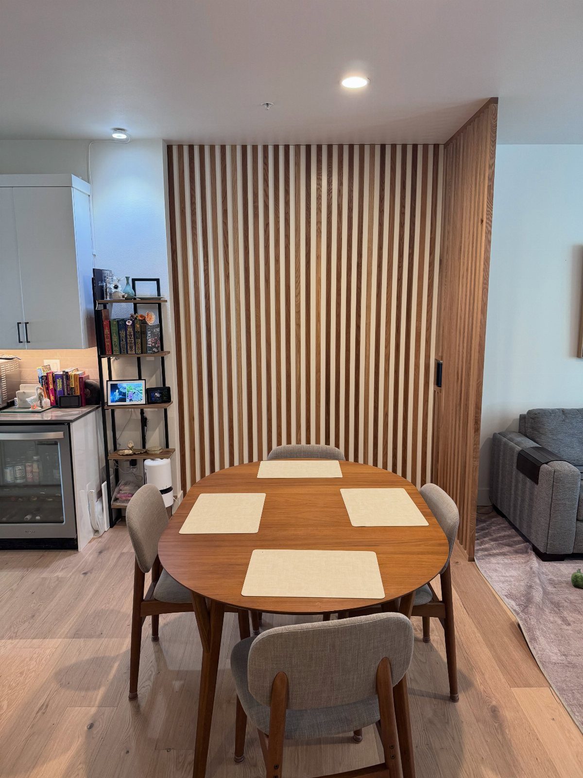 Wooden dining table and chairs in an open concept studio apartment interior