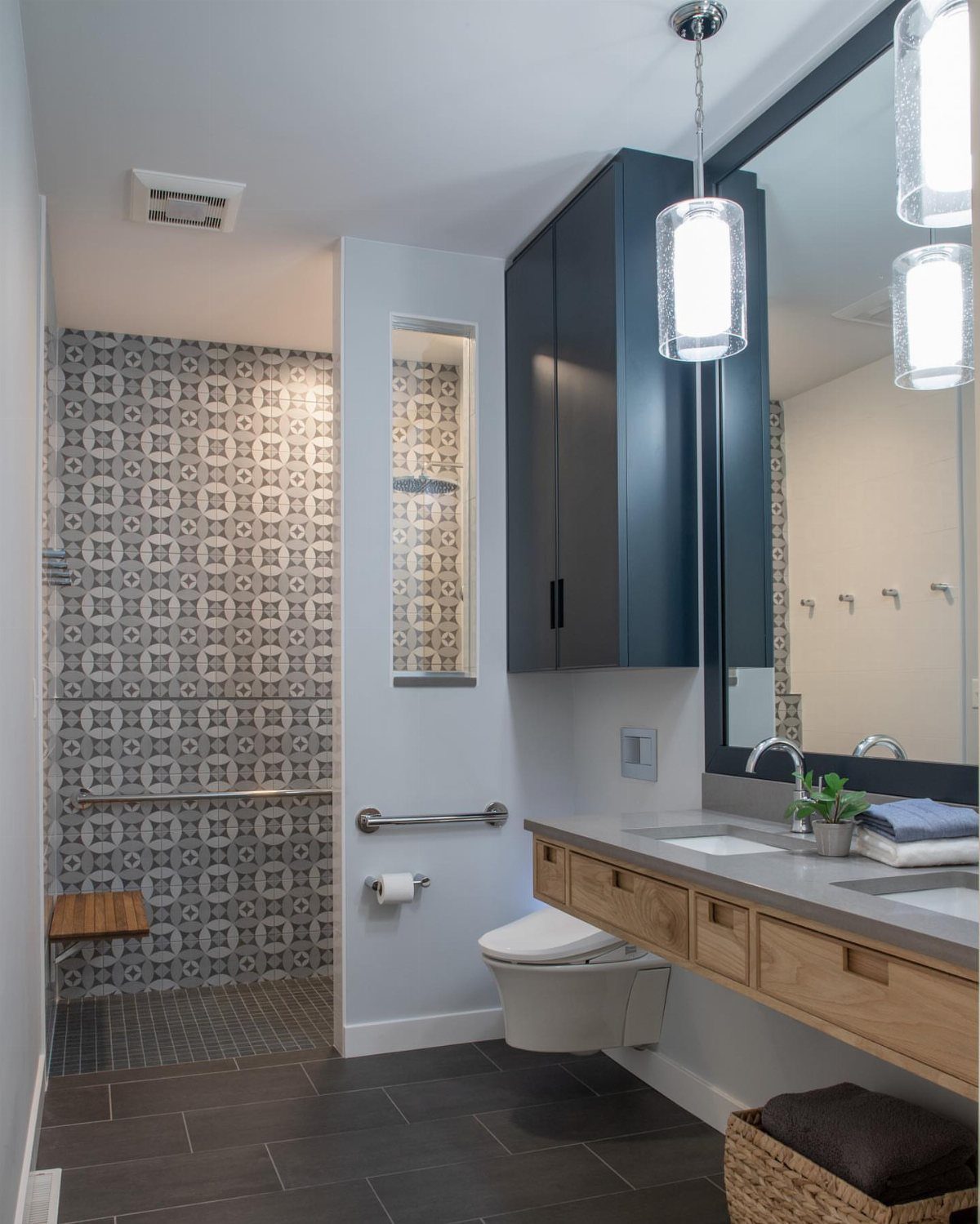 Modern small bathroom with a metal grab bar installed next to the toilet.