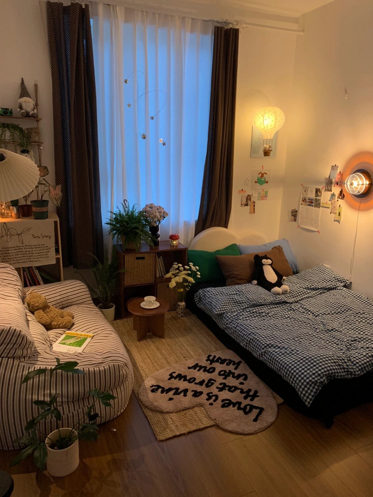 Small bedroom nook with a striped sofa, checkered bed, and heart-shaped rug.