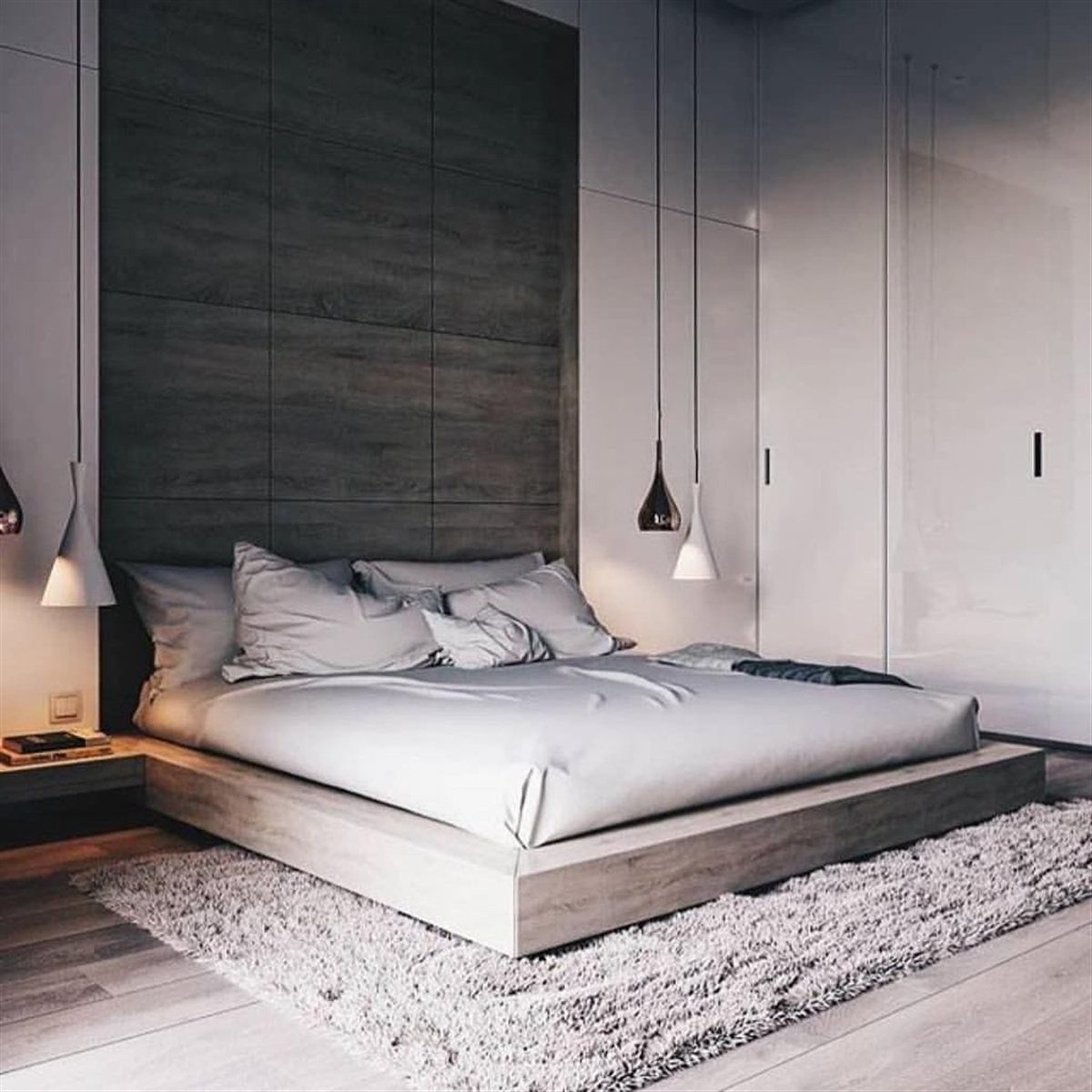 Low-profile platform bed with white linens on a grey shag rug in modern bedroom
