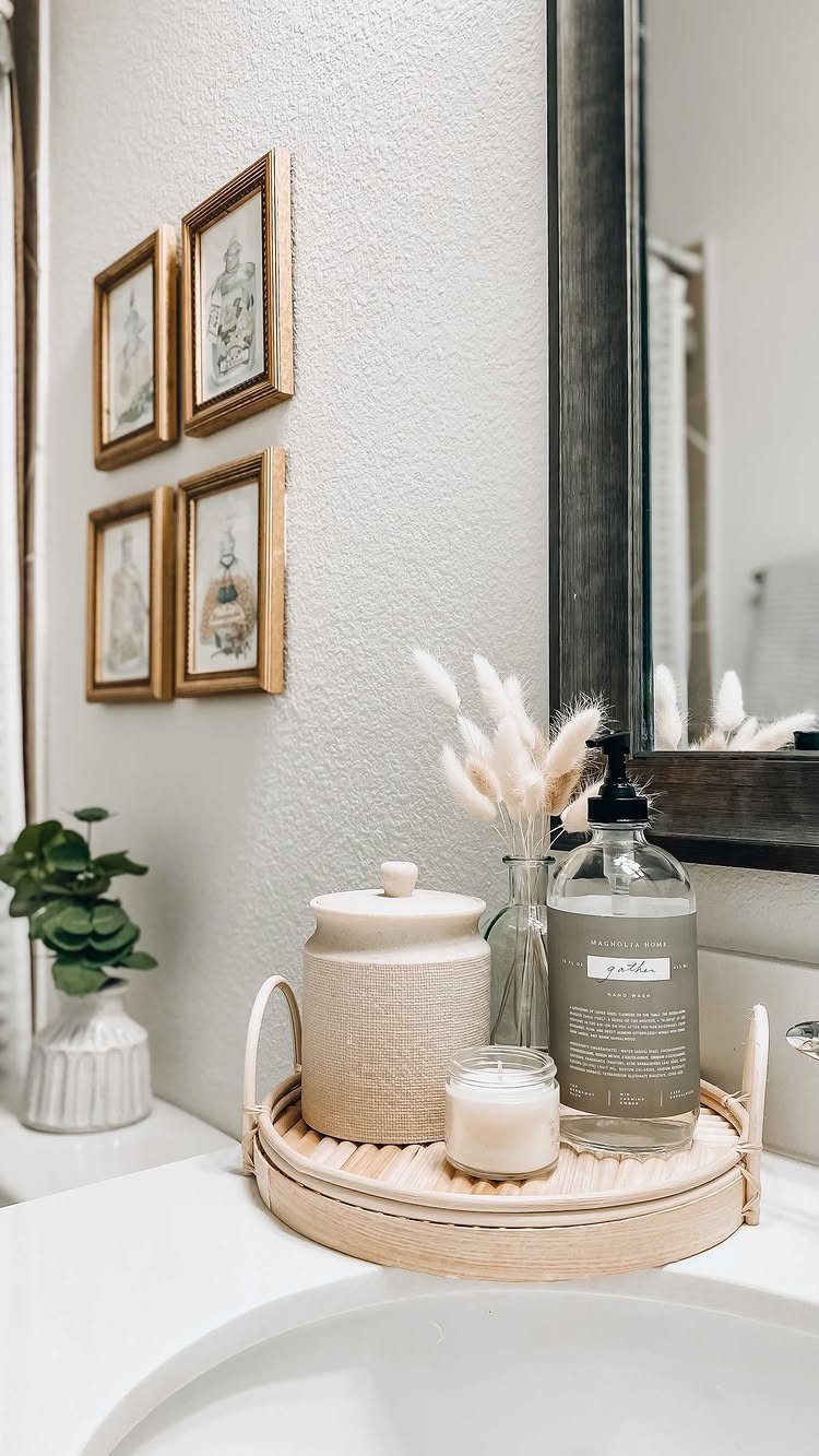 Woven bamboo bathroom caddy holding soap, a candle, and a jar on white counter