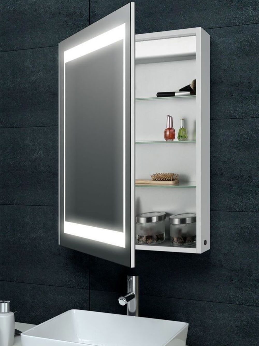 White mirrored bathroom cabinet open to reveal shelves with toiletries on dark tiles