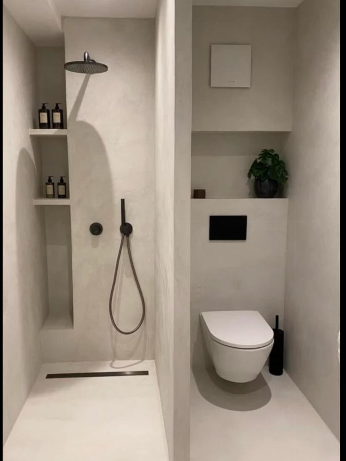 Modern white small bathroom with black shower fixtures and a wall-hung toilet.