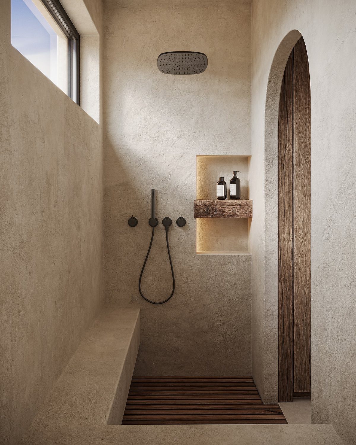 Beige stone shower with black fixtures, recessed niche, and wooden slatted floor mat.