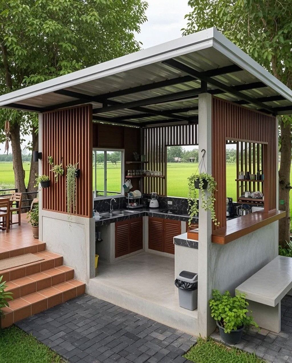 Outdoor kitchen with concrete base and wooden accents on a paved stone patio