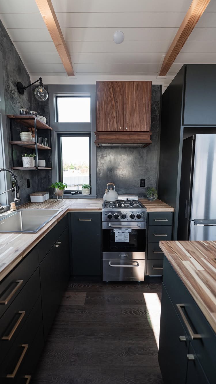 Compact kitchen with dark cabinets, wood countertops, and a small window.
