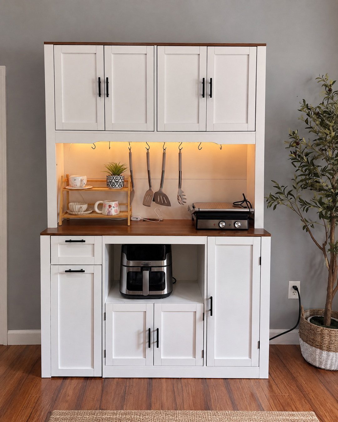 White wooden kitchen hutch with brown countertops and built-in storage for appliances.