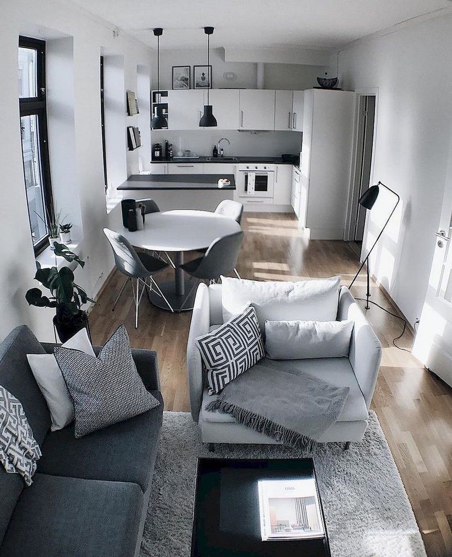 Studio apartment interior featuring a living area, dining table, and kitchen in one space.
