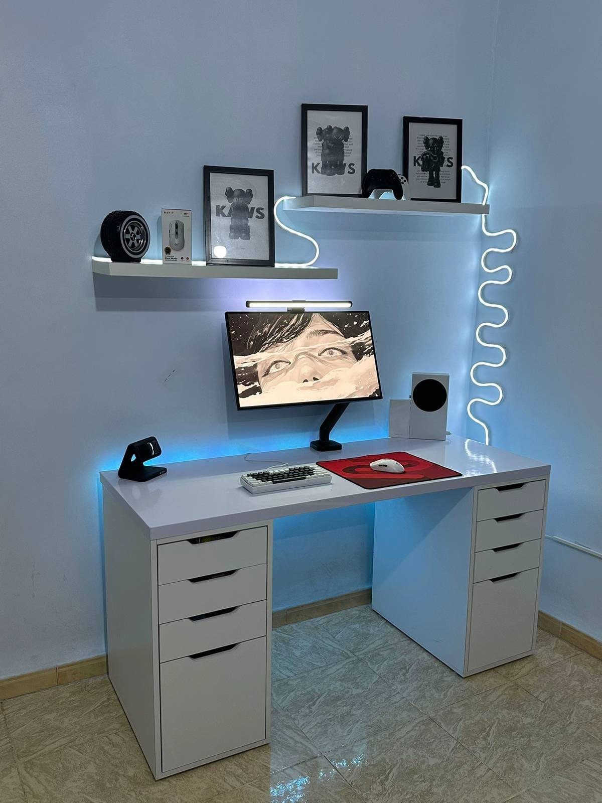 White modern computer desk with floating shelves and LED lighting in a small room