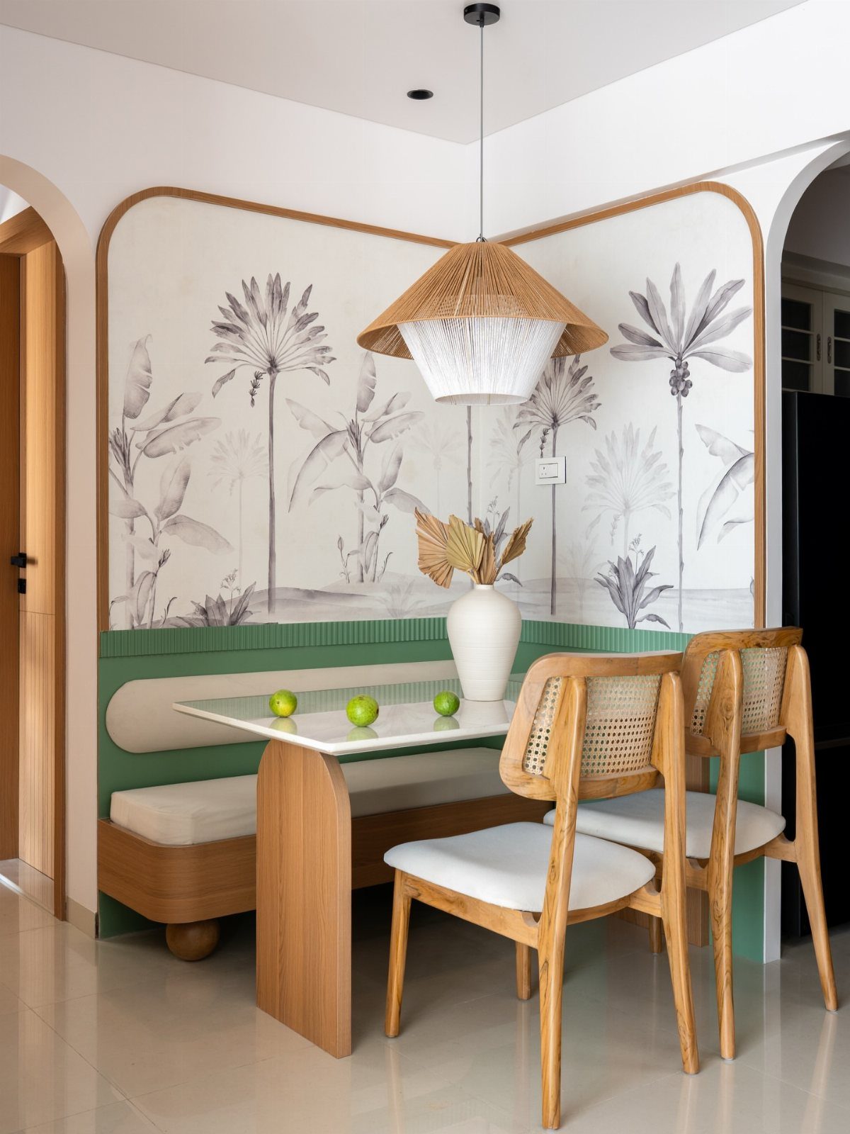 Built-in wooden banquette seating with white cushions in a botanical themed dining area.