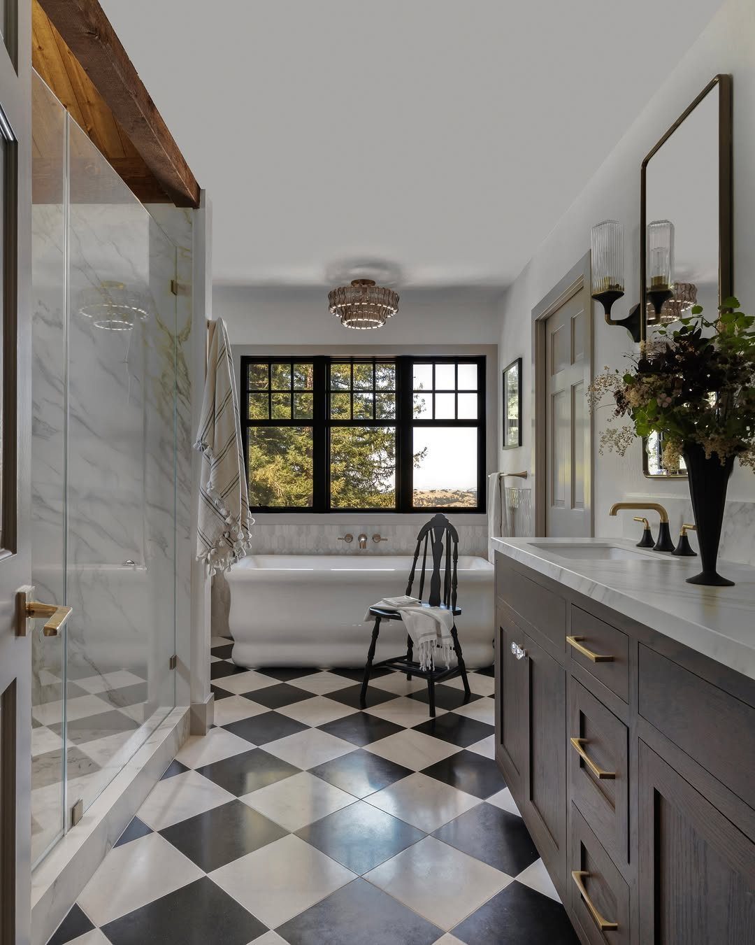 Black and white checkerboard floor tiles in a modern bathroom with a bathtub.